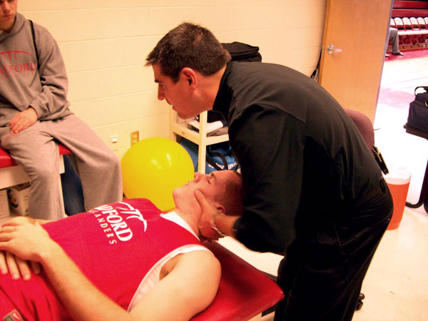 Dr. Bolin works on Radford Univ. athletes sports medicine doctor delmas bolin working on athlete's neck pain